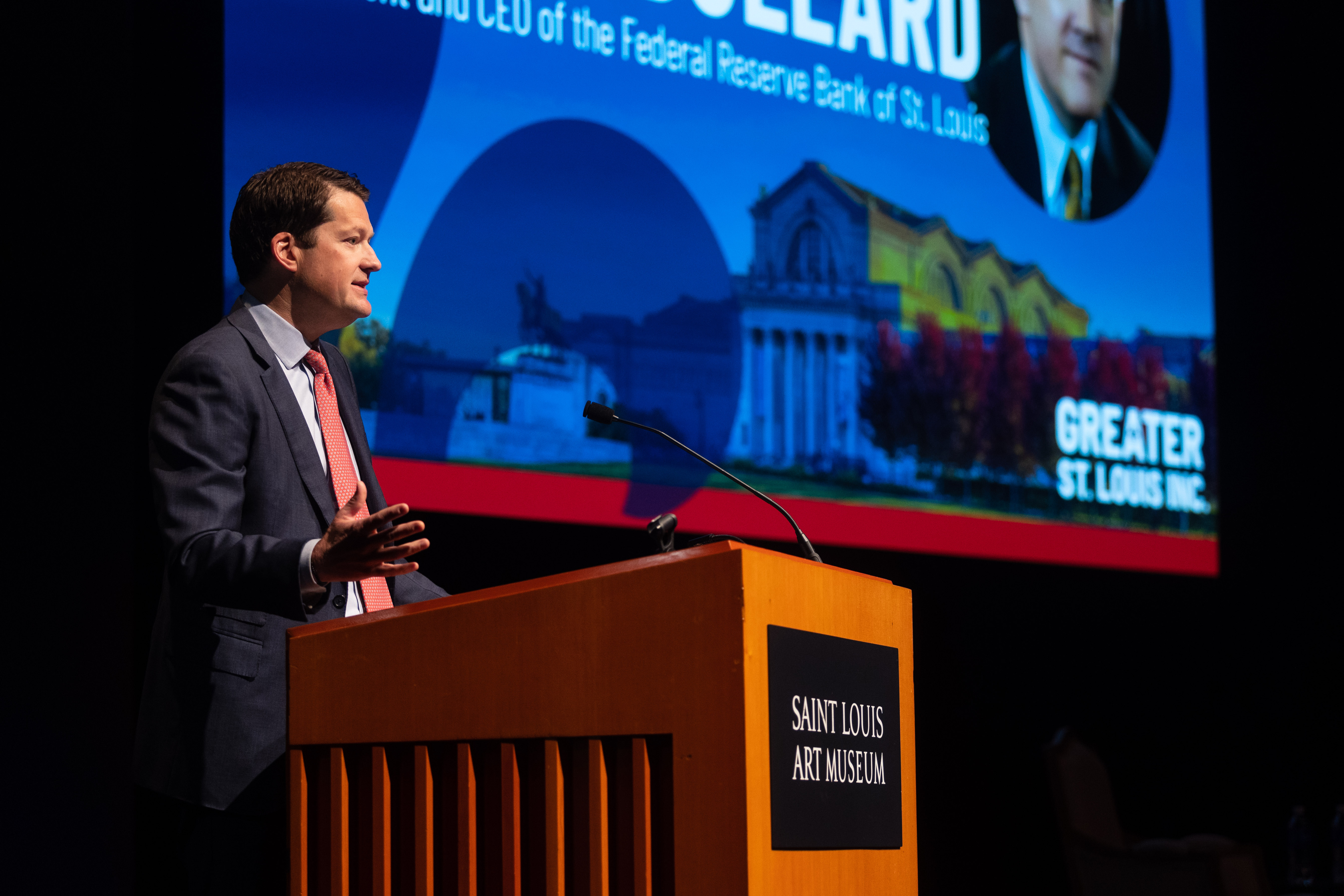 John W. Kemper addresses the audience behind a podium on the stage at the Saint Louis Art Museum
