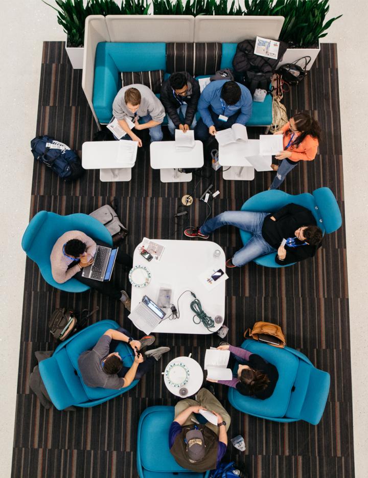 Overhead shot of people working on computers in a modern office environment