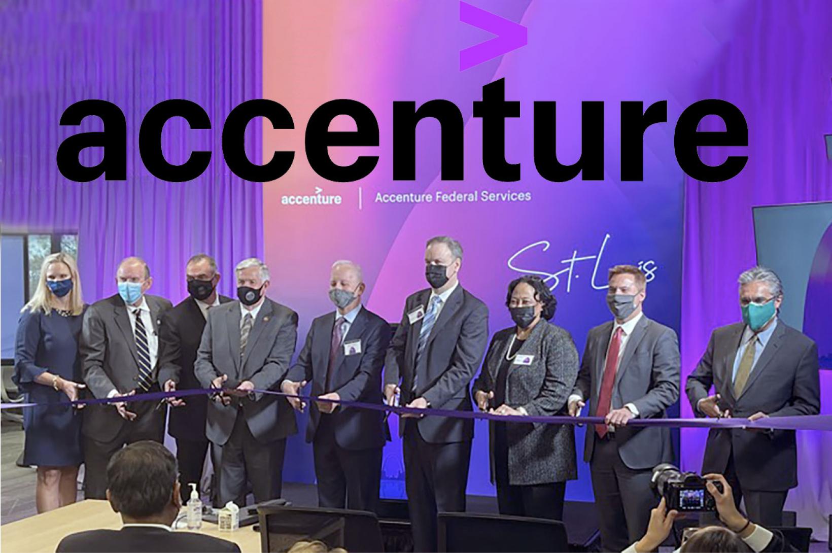 A group of business people cut a ribbon on stage with the accenture logo displayed behind them