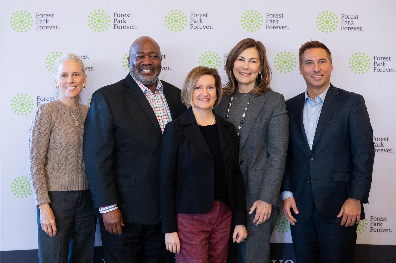 A group of civic leaders pose for a photo at a Forest Park Forever breakfast