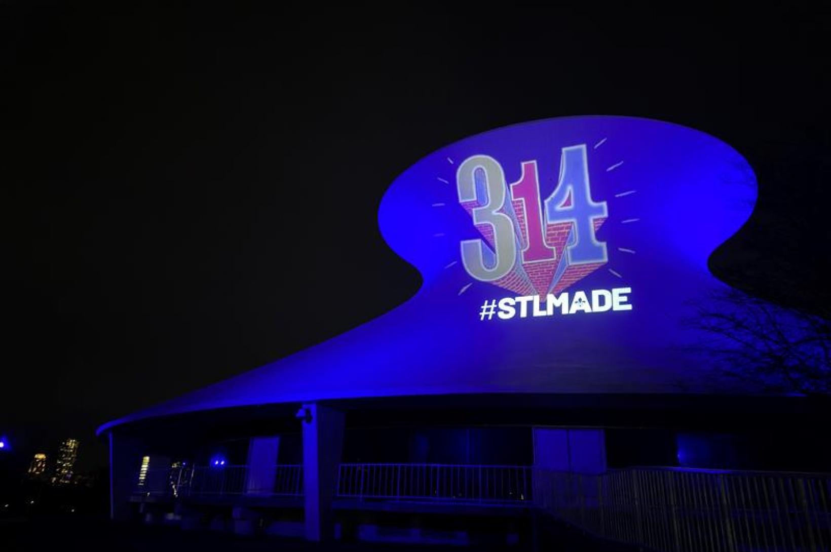 Set against a dark night sky, the Planetarium is illuminated with the 314 day logo on 314 Day 2023.