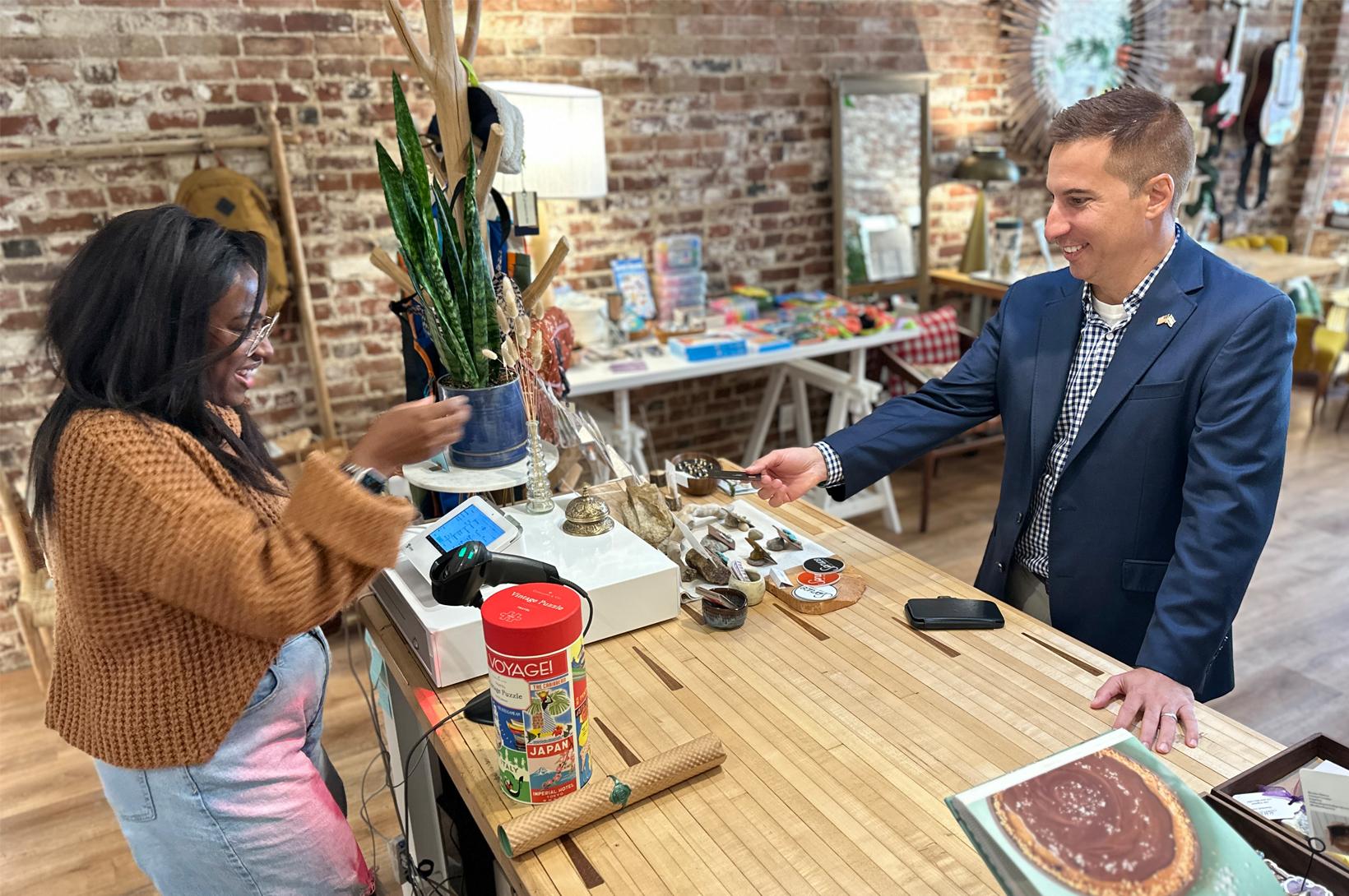 Jason Hall purchases an item from Spruce Craft + Collective in Greenville, IL.