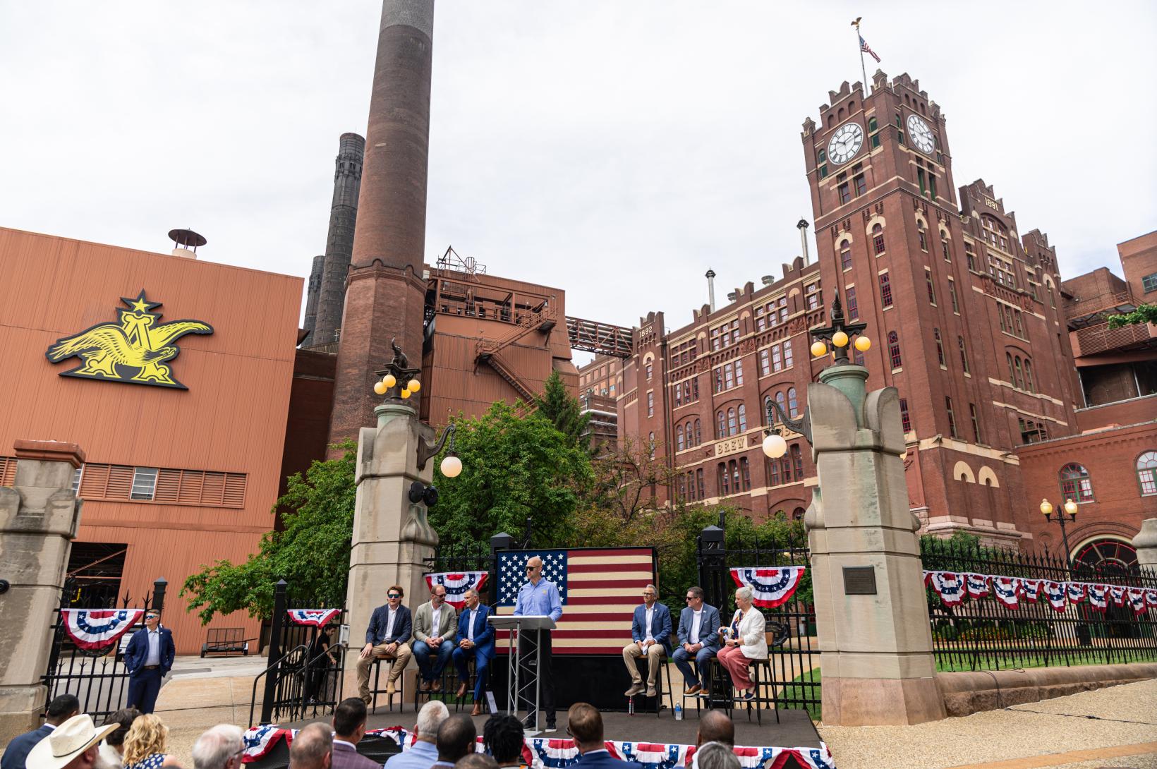 Leaders sit on a dias outside the Anheuser-Busch Brewery in St. Louis Missour.