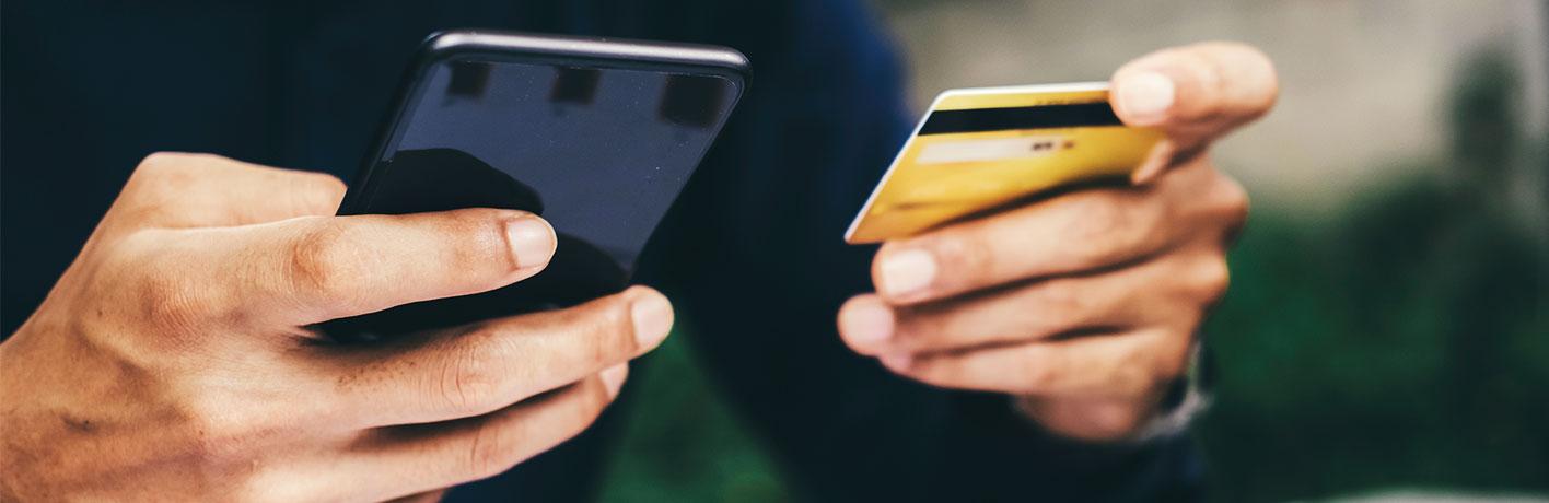 customer-shopping-online-pay-by-credit-card-2021-09-03-01-33-53-utc.jpg Two hands holding a credit card and a cell phone