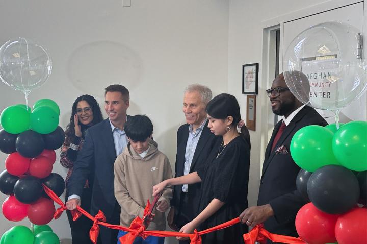 Local leaders and participants celebrate the Afghan Community Center ribbon cutting event