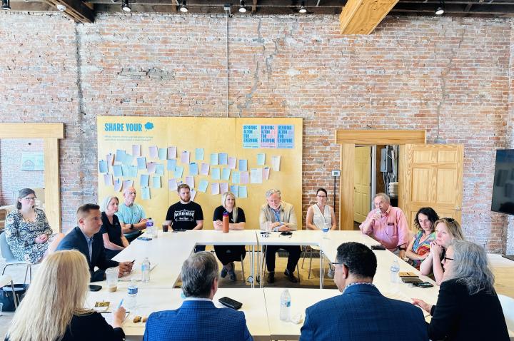 A group of Alton business leaders sits in a roundtable discussion at Alton Works