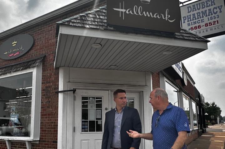 Jason Hall talks to a business owner in downtown Mascoutah, Illinois