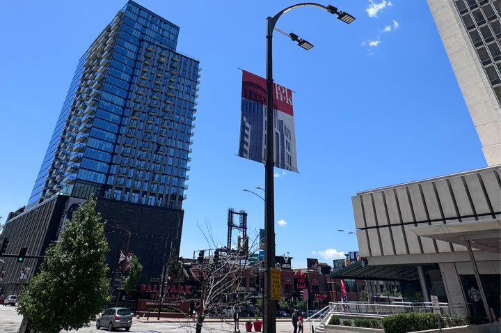 A photo of Downtown St. Louis at Ballpark Village, with an HOK street banner in the foreground.