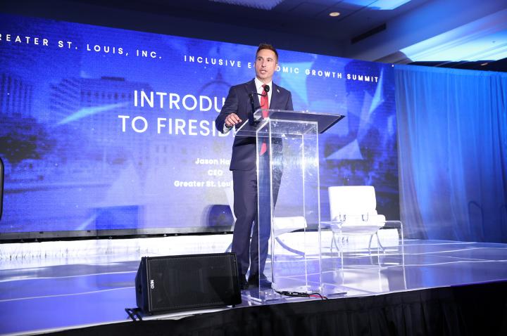 CEO Jason Hall speaks on stage at the Inclusive Economic Growth Summit.