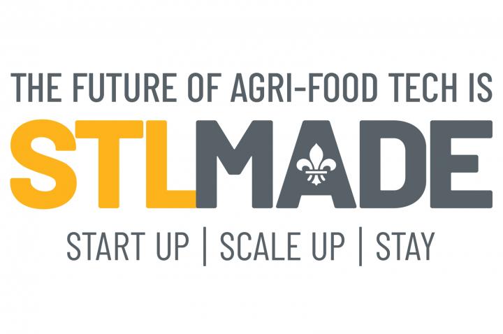 A yellow and gray logo that reads "The Future of AgriFood Tech is STLMade" 