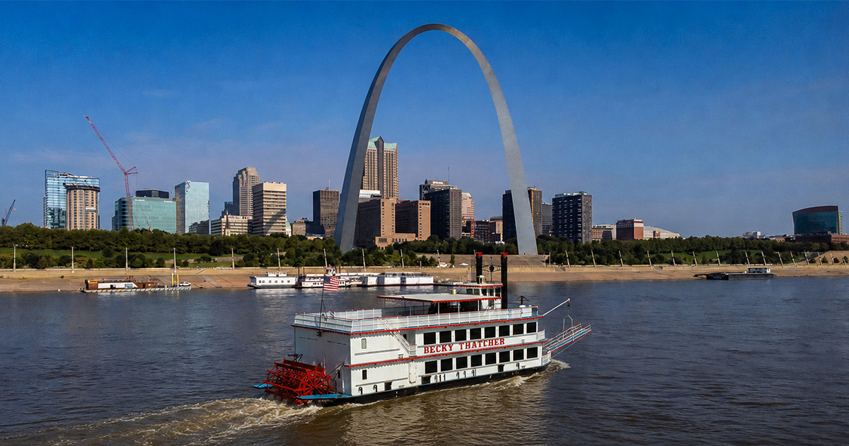 The Becky Thatcher paddle steamer on the Mississippi River before the Gateway Arch and St. Louis skyline