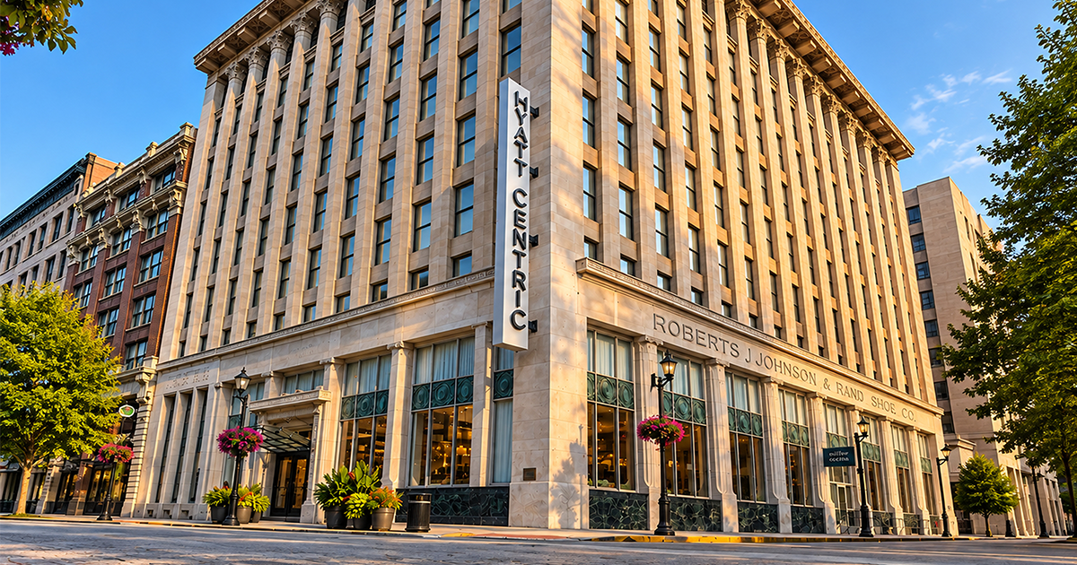 Hyatt Centric hotel in a historic Roberts J Johnson & Rand Shoe Co. building with a vertical sign and street-level windows